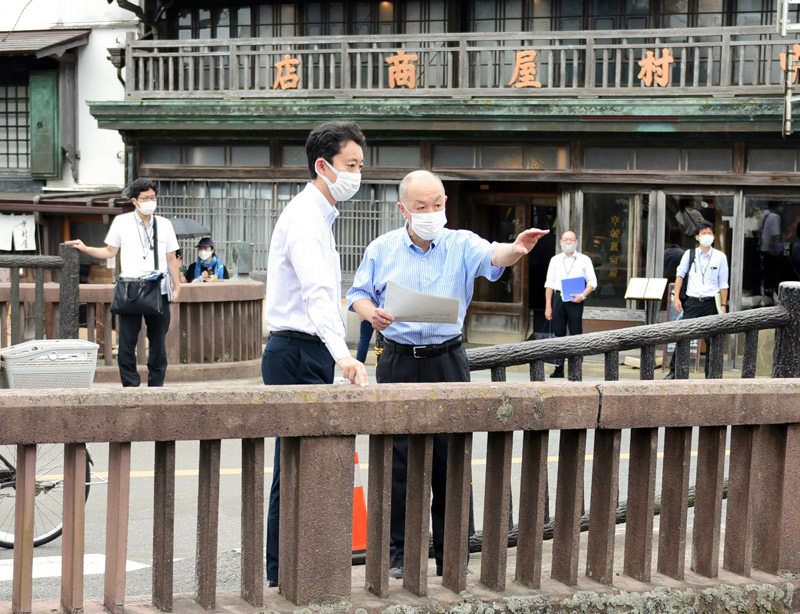 宇井市長(右)から佐原の町並みについて説明を受ける熊谷知事=2日、香取市
