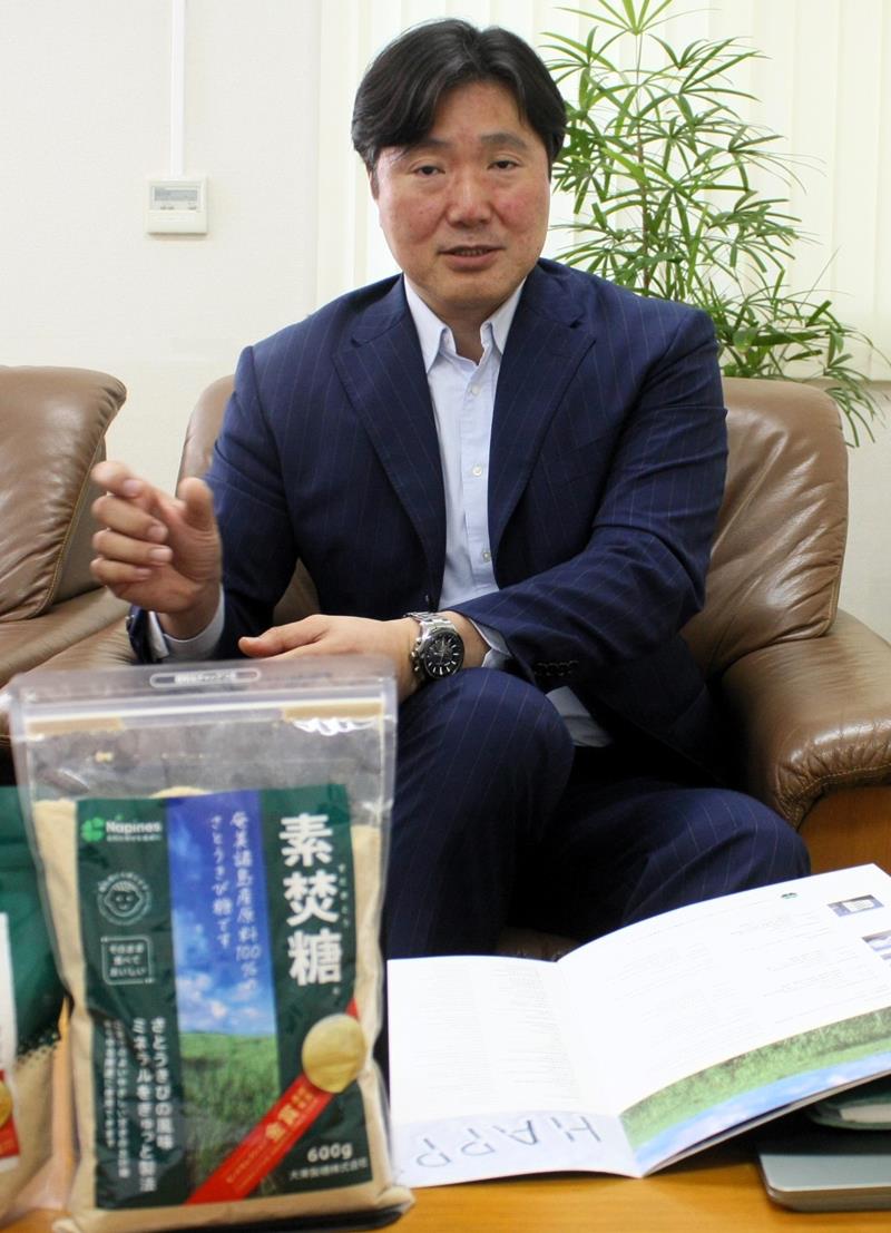 看板商品「素焚糖」について説明する木村代表取締役