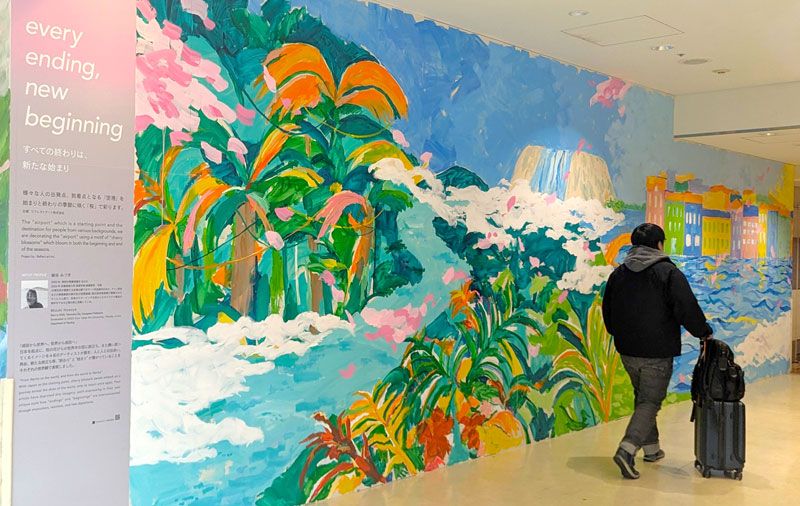 桜の花びらが美しい自然の中を舞う様子を描いた壁画=成田市