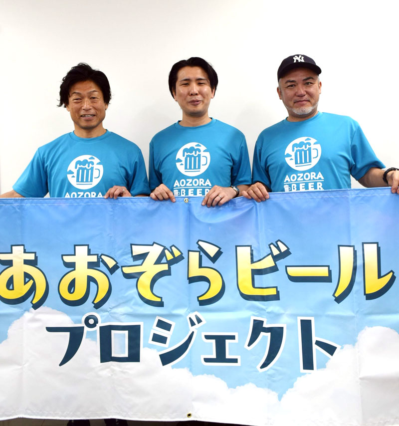 森沢さんのエッセー集をイメージした「リアルあおぞらビール」をＰＲする山崎さん（左端）ら＝船橋市役所